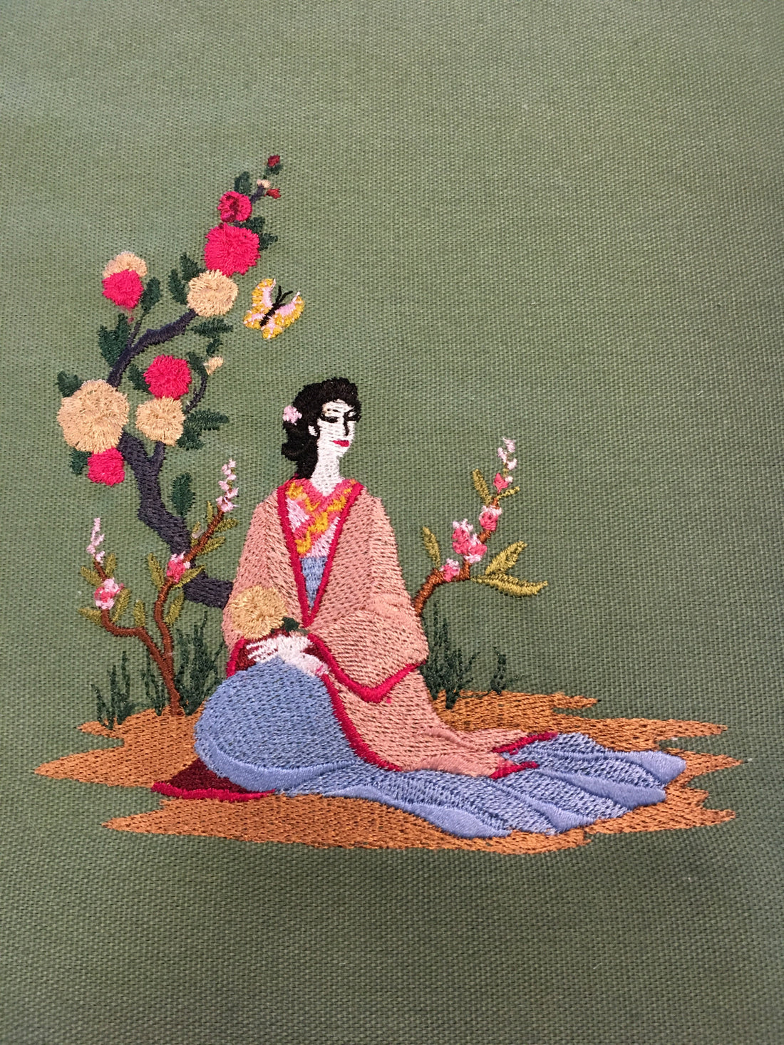 A handcrafted embroidery piece in progress, showing the artistry and detail of custom embroidery work