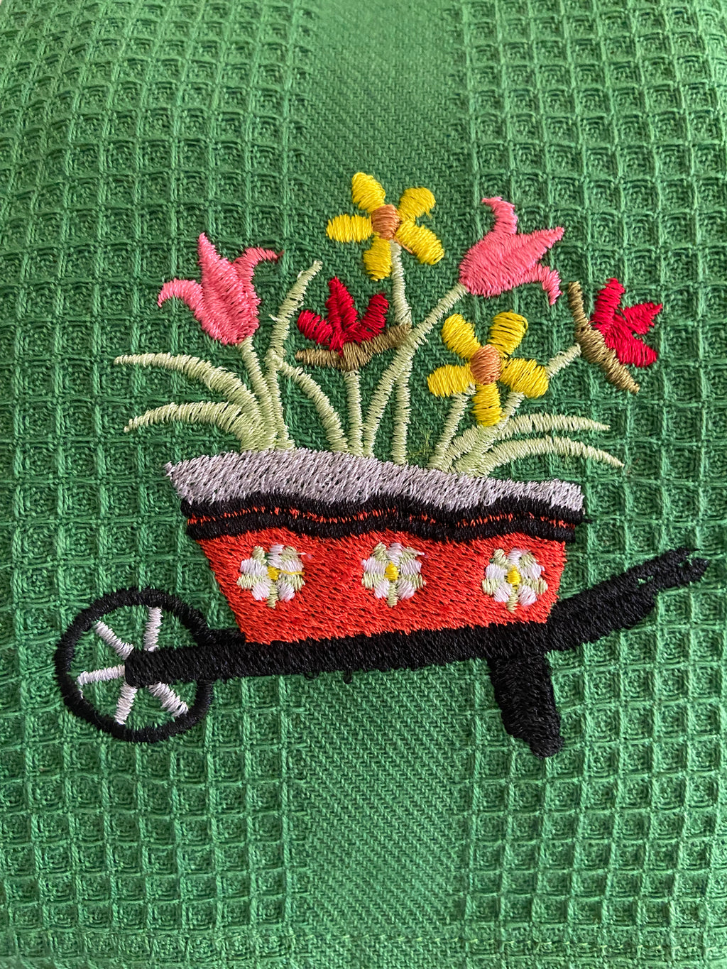 Flowers in a wheelbarrow Kitchen Towel