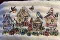 Embroidered design of birdhouses and flowers on a textured fabric background